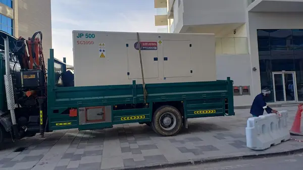 10 ton Hiab crane truck lifting generator on construction site in Abu Dhabi