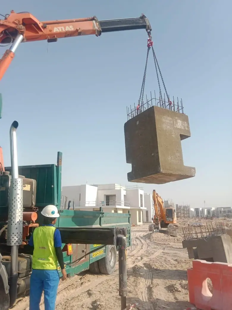 12 ton Hiab crane truck lifting concrete materials on site in Abu Dhabi